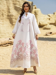 Detailed embroidery on white jacquard maxi dress with elegant beaded cutout neckline