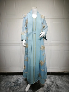 Detail of light blue abaya set featuring intricate gold palm leaf embroidery on chiffon