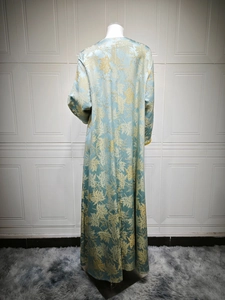 Rear view of light blue jacquard long dress featuring golden maple leaf embroidery details