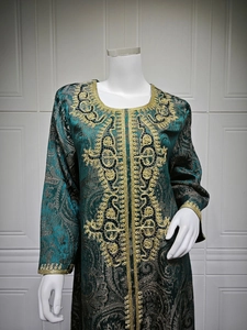 Detail of dark teal Kaftan with intricate gold embroidery and beadwork on the neckline