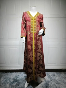 Detailed embroidery with gold sequins and beads on a burgundy kaftan dress