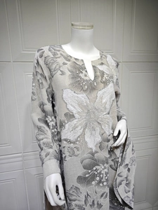 Detail of elegant V-neckline with white sequin embroidery and floral patterns