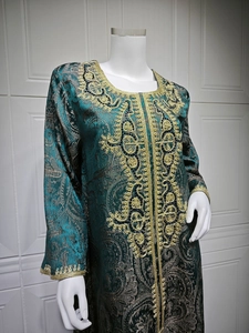 Detailed golden embroidery and paisley jacquard pattern on dark green kaftan dress