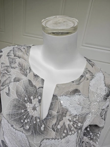 Detail of embroidered floral sequins and beadwork on a gradient V-neck women's dress