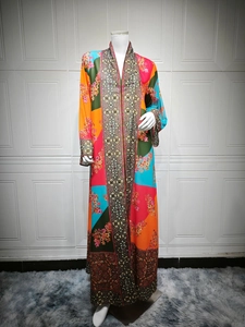 Detailed close-up of vibrant floral print and rhinestone patterns on this long dress