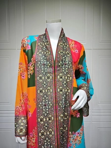 Detail of colorful ethnic floral print and rhinestone embellishments on long sleeve maxi dress