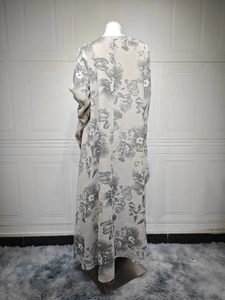 Detail of elegant black and white floral print on a long breathable cotton cardigan