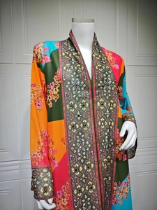 Detail view of ethnic floral print kaftan dress with rhinestones and colorful patterns