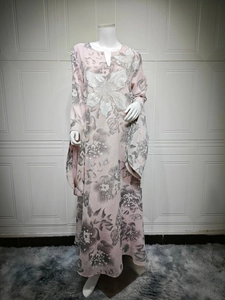 Close-up of pink floral dress featuring intricate white 3D flower appliques and beadwork