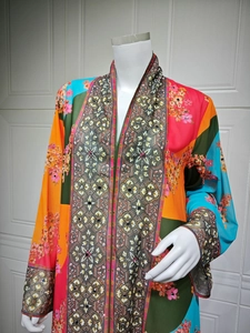 Detailed pattern of colorful bohemian printed maxi dress with sequins and geometric art