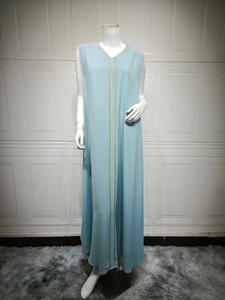 Detail of light blue sleeveless maxi dress with elegant V-neck and gold trim embroidery