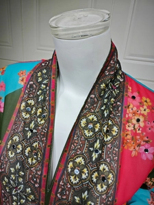 Detail of floral chiffon cardigan featuring ethnic prints and mirror sequin embellishments