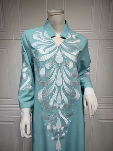 Detail of silver embroidery and contrast cuffs on long-sleeved ethnic dress