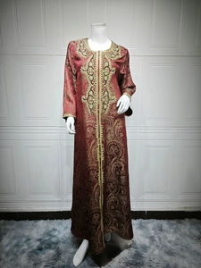 Detailed close-up of intricate gold embroidery on a burgundy long sleeve Kaftan dress