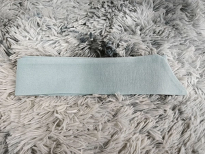 Detail of the light blue embroidered fabric sash showing texture and neat stitching