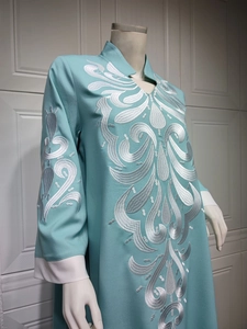 Detailed silver embroidery on a light blue long ethnic dress with stand collar