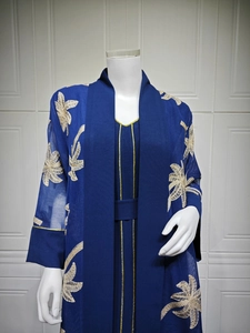 Detail of navy blue abaya with gold palm leaf embroidery and elegant piping