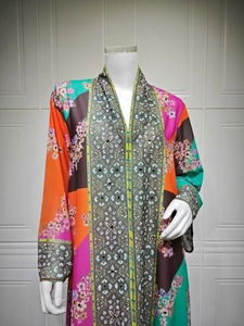 Detail of multi-color kaftan dress featuring floral prints and rhinestone center band