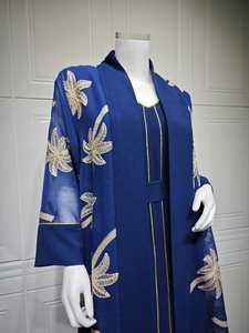 Detail of royal blue abaya featuring gold leaf embroidery and sheer cardigan sleeves