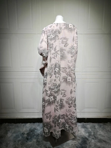 Detailed back view of a long pink floral kaftan dress with grey flower embroidery patterns