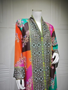 Detailed view of colorful floral print and intricate beadwork on a bohemian maxi dress