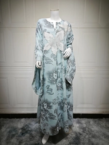 Detail view of light blue maxi dress featuring delicate white floral embroidery and sequins