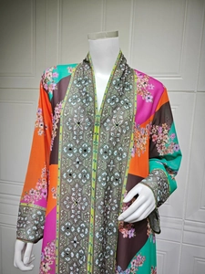 Close-up of bohemian floral maxi dress featuring ethnic patterns and sequin details