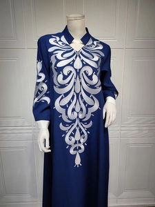 Intricate silver embroidery detail on navy blue kaftan sleeve and neckline