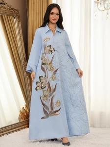 Detail of light blue abaya featuring floral sequin embroidery and pleated texture design