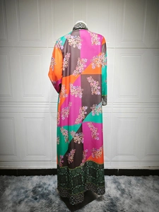 Back view of a long floral patchwork maxi dress featuring bohemian prints on a mannequin