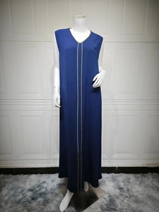 Detail of dark blue V-neck maxi dress featuring golden trim and elegant sleeveless cut