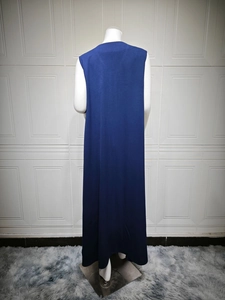 Rear view of long navy blue sleeveless dress with premium draped fabric on mannequin