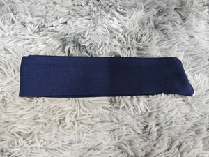 Detailed close-up of the dark blue embroidered fabric texture and weave for the long dress