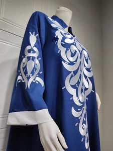 Detail of white embroidery and contrast cuffs on dark blue ethnic maxi dress for women