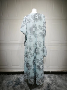 Close-up detail of light blue floral dress with dark grey ink art flower pattern print