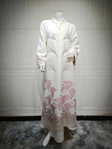 Detail of cream long-sleeve Abaya with leaf embroidery and rhinestone collar embellishments