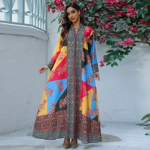 Elegant floral print kaftan dress with colorful patchwork and geometric trim details