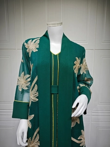 Detail of dark green two-piece abaya set with elegant golden leaf embroidery on sleeves