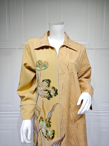Detailed sequin flower embroidery and textured pleats on a mustard yellow ethnic dress