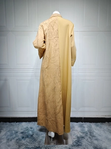 Detail view of mustard yellow jacquard long dress with embroidered textured leaf patterns