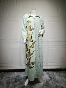 Detailed embroidery of gold and green flowers on mint green ethnic abaya dress
