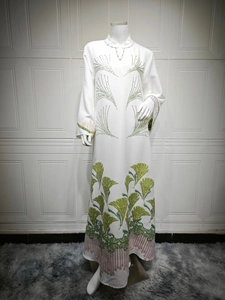 Detail of white jacquard fabric with elegant green embroidery and gradient patterns