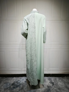 Detail of mint green long dress with unique asymmetric leaf vein pleated texture