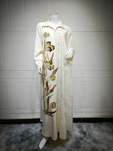 Detail view of ethnic embroidery on cream long dress with intricate floral sequins