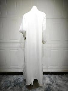 Rear view of white textured Abaya dress featuring embroidered floral cuffs and hemline