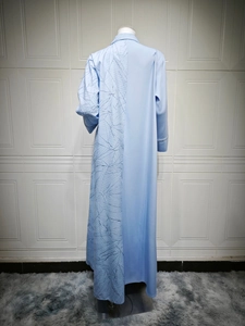 Detailed view of light blue maxi dress featuring unique leaf-vein embossed texture and stitching