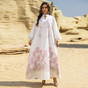 White embroidered kaftan dress with pink and purple floral details for women in desert