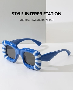 Detail of retro square sunglasses with bold blue and white stripes and dark grey lenses