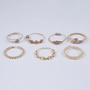 Set of seven handmade 14K gold-filled pearl rings in white, pink and lavender tones