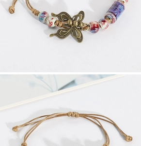 Detail of woven bracelet featuring a vintage bronze butterfly charm and colorful ceramic beads